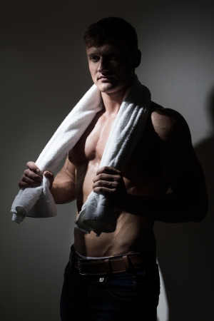 Young handsome man with white towel over his neckの写真素材