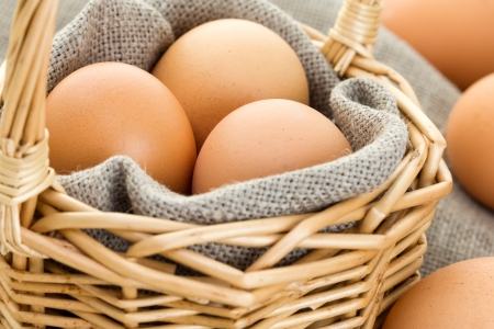 Close-up of brown eggs in a basketの写真素材