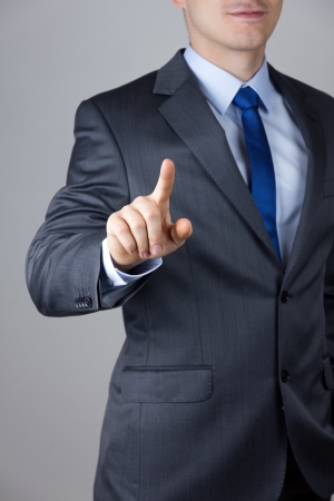 Business man touching an imaginary screenの写真素材