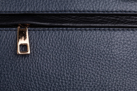 Dark blue natural leather texture with metallic zipper backgroundの写真素材