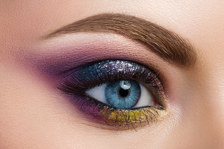 Close-up view of blue female eye with beautiful modern creative make-upの写真素材