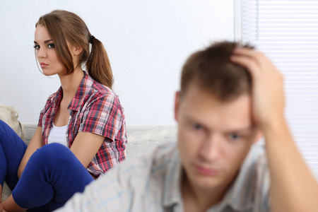 Portrait of unhappy young couple having problems. Focus on womanの写真素材