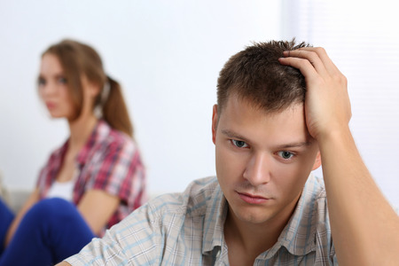 Portrait of unhappy young couple having problems. Focus on manの写真素材