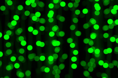 Christmas glittering green lights background. Holiday abstract texture