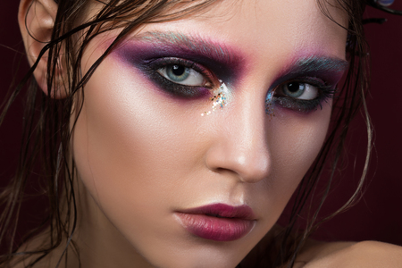 Beauty portrait of a young girl with fashion creative make-up. Colourful smoky eyes. Beauty faceの写真素材