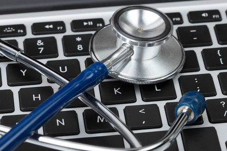 Stethoscope lying on laptop keyboard closeup. Medical concept. Modern medicine and high tech...