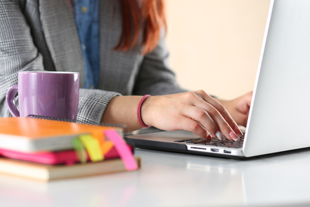 Close up view of businesswoman, designer or student hands working on laptop. Online distant education, writing blog, freelance, mobile payments, working at office or at home concept.の写真素材