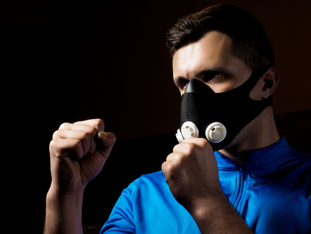 Man boxing in training mask. Respiratory muscle conditioning conceptの写真素材