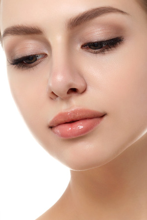 Close up view of young beautiful caucasian woman isolated over white background. Lips contouring, SPA therapy, skincare, cosmetology and plastic surgery conceptの写真素材