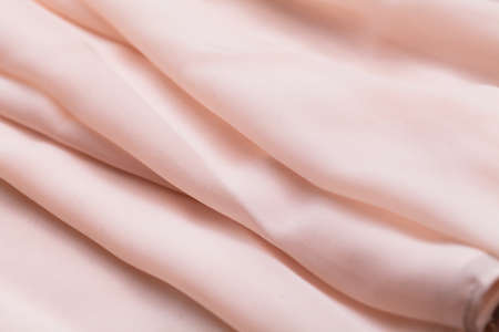 Pink light cloth, fabric, textile with a lot of folds, plaits, creasesの写真素材