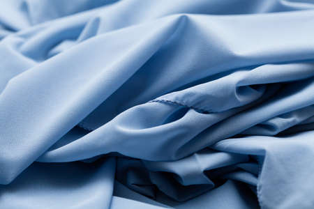 Blue light cloth, fabric, textile with a lot of folds, plaits, creasesの写真素材