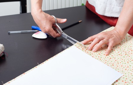 Dressmaker at work, building patterns, hands, modeling, measuring, fashion sewing machine material...
