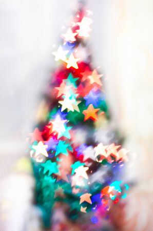 Blured sparks of light on cristmas tree, spruce lights on backgroundの写真素材