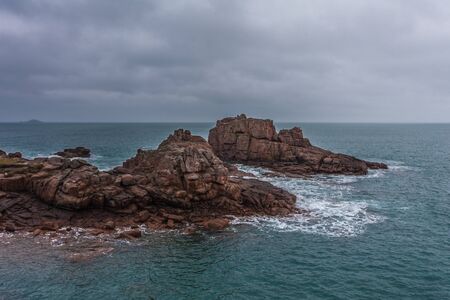 Perros Guirec, Ploumanac'h Lighthouse, Mean Ruz Lighthouse, la Manche,at winter, rocks and wavesの写真素材