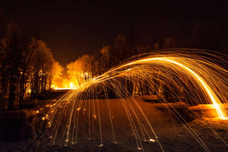 Fire painting at snow winter at nightの写真素材