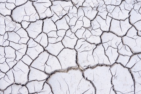 the gray cracked clay in the sunの写真素材