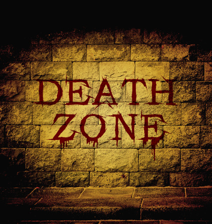 death zone blood text at the brick wall with dim lightの写真素材