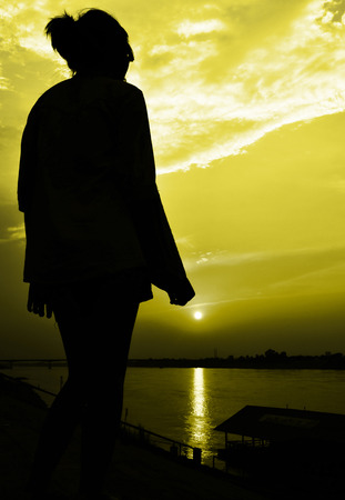 sun rise with girl siluate scene abstract,yellow color toneの写真素材