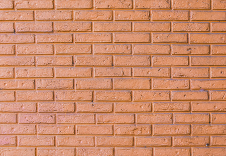 brick wall with orange color paint,old conditionの写真素材