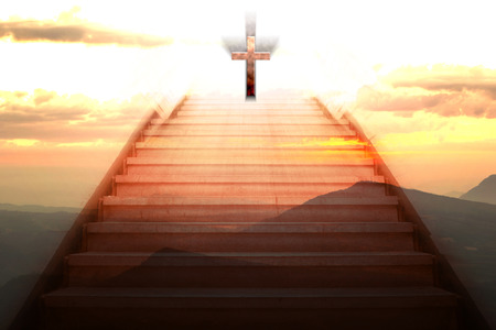 staircase going up to the christian cross with mountain backgroundの写真素材