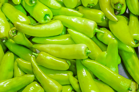 Many green chillis are overlapped, shot from supermarketの写真素材