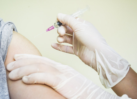 Doctor preparing a patient injection, picture for about medical