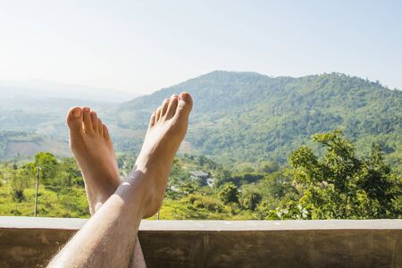 foot with mountain nature background, relax travel conceptの写真素材