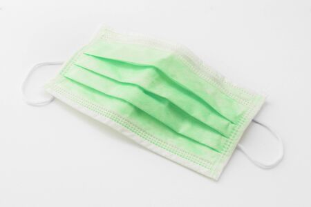 A green medical mask on isolated backgroundの写真素材