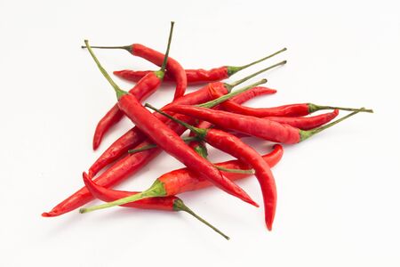 Many red chillis are overlapped, isolated backgroundの写真素材