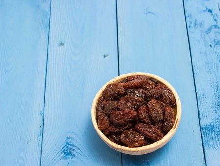 the raisins on a blue board closeupの写真素材