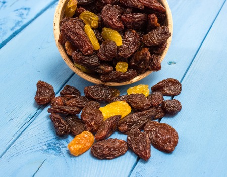 the raisins on a blue board closeupの写真素材