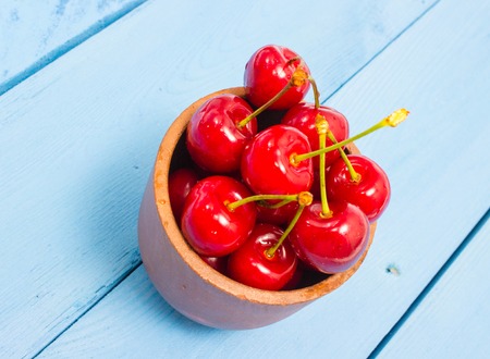 fresh cherries on a blue board closeupの写真素材
