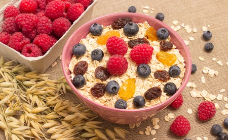 Healthy homemade oatmeal with berries and rasberry for breakfast.