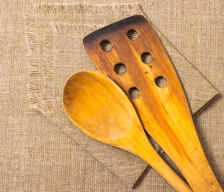 Wooden kitchen tools on the background of the canvasの写真素材