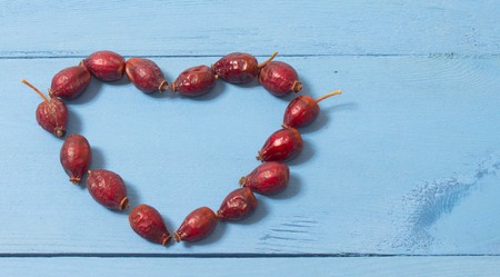 Dried fruit of hawthorn on the blue boardの写真素材