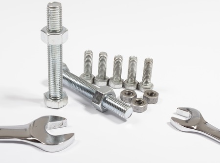 Screw, nut, wrench wrench, closeup on white background