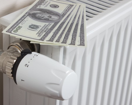Closeup of a radiator thermostat with many dollars.の写真素材
