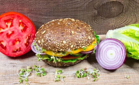 Vegetarian sandwich with fresh vegetables on a board.の写真素材