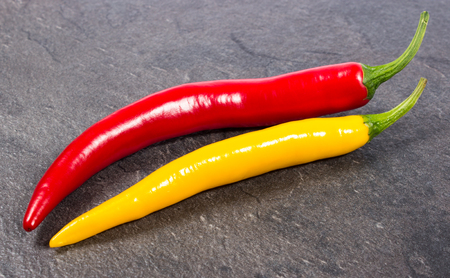 Closeup of a chili pepper on a black background.の写真素材