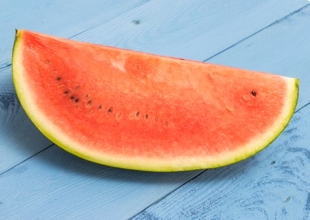 fresh watermelon on a blue board closeupの写真素材