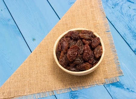 the raisins on a blue board closeupの写真素材