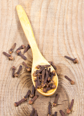 Closeup of dried cloves on a wood board.の写真素材