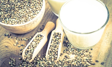 Close Up of hemp milk and seeds on wooden background .の写真素材