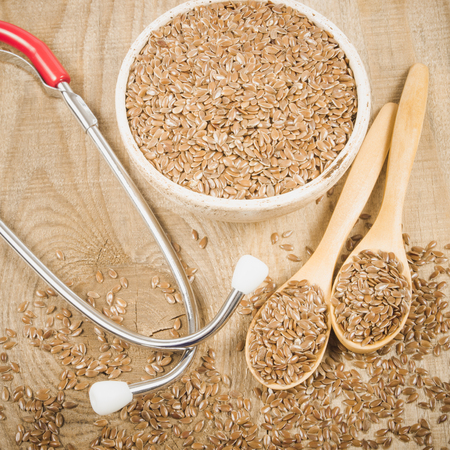 Close up of flaxseed and stethoscope - the concept of medicinal properties.の写真素材