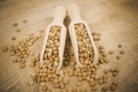 Raw green lentils on the wooden background .の写真素材