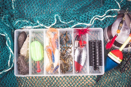 Open storage box with accessories for fishing and fishing baits.の写真素材