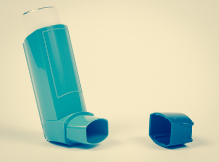 Inhaler to treat asthma on a white background.