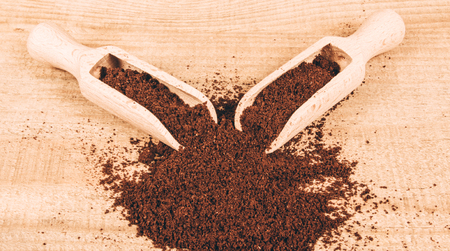 Close up of ground coffee on the wooden table.の写真素材