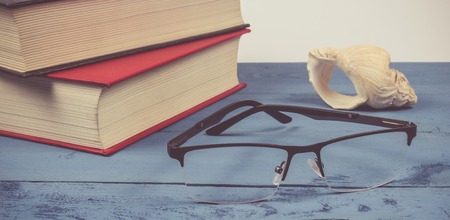 Book with glasses on the wooden background. Education concept.の写真素材