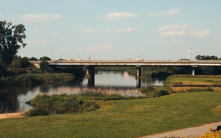 Konin, Poland - July 22, 2017: View on bridge and embankment of Warta river in polish town Konin, Greater Poland provinceのeditorial素材